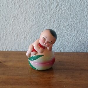 Vintage Asian Chinese Baby Girl Resting On A Peach Pencil Sharpener.